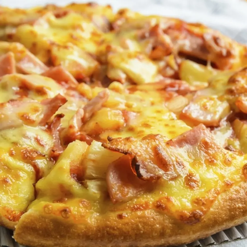 Homemade Pizza Crust Topped With Ham and Pineapple